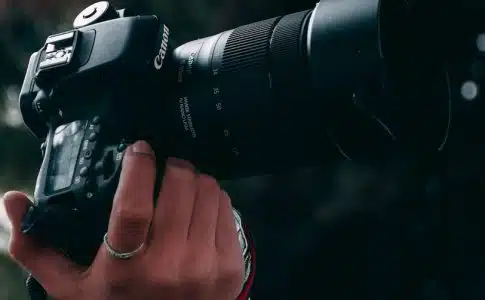 person holding black canon dslr camera