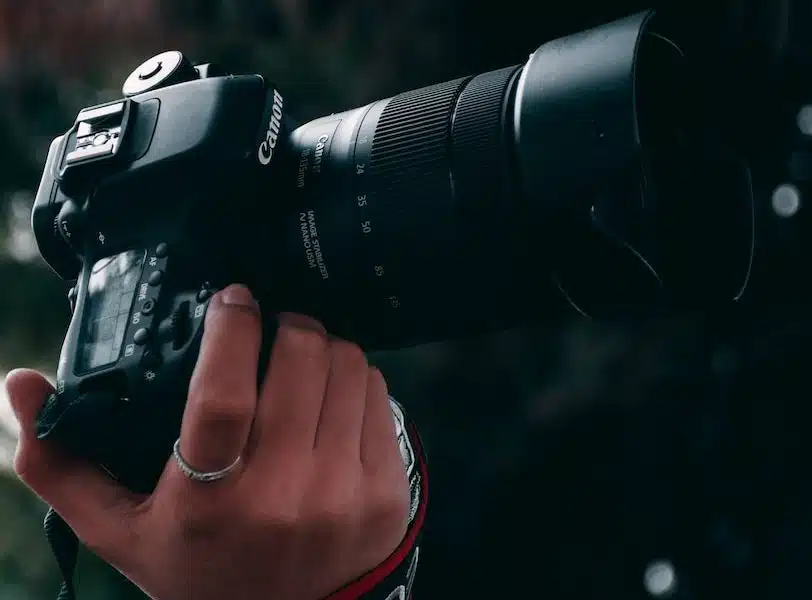 person holding black canon dslr camera